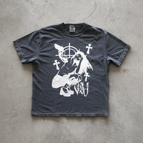 May include: Dark gray t-shirt featuring a graphic design of a stylized female figure holding guns, surrounded by crosses and a target symbol. The style is reminiscent of vintage punk or grunge aesthetics. The graphic is printed in white. The shirt appears to be made of a soft, comfortable fabric.