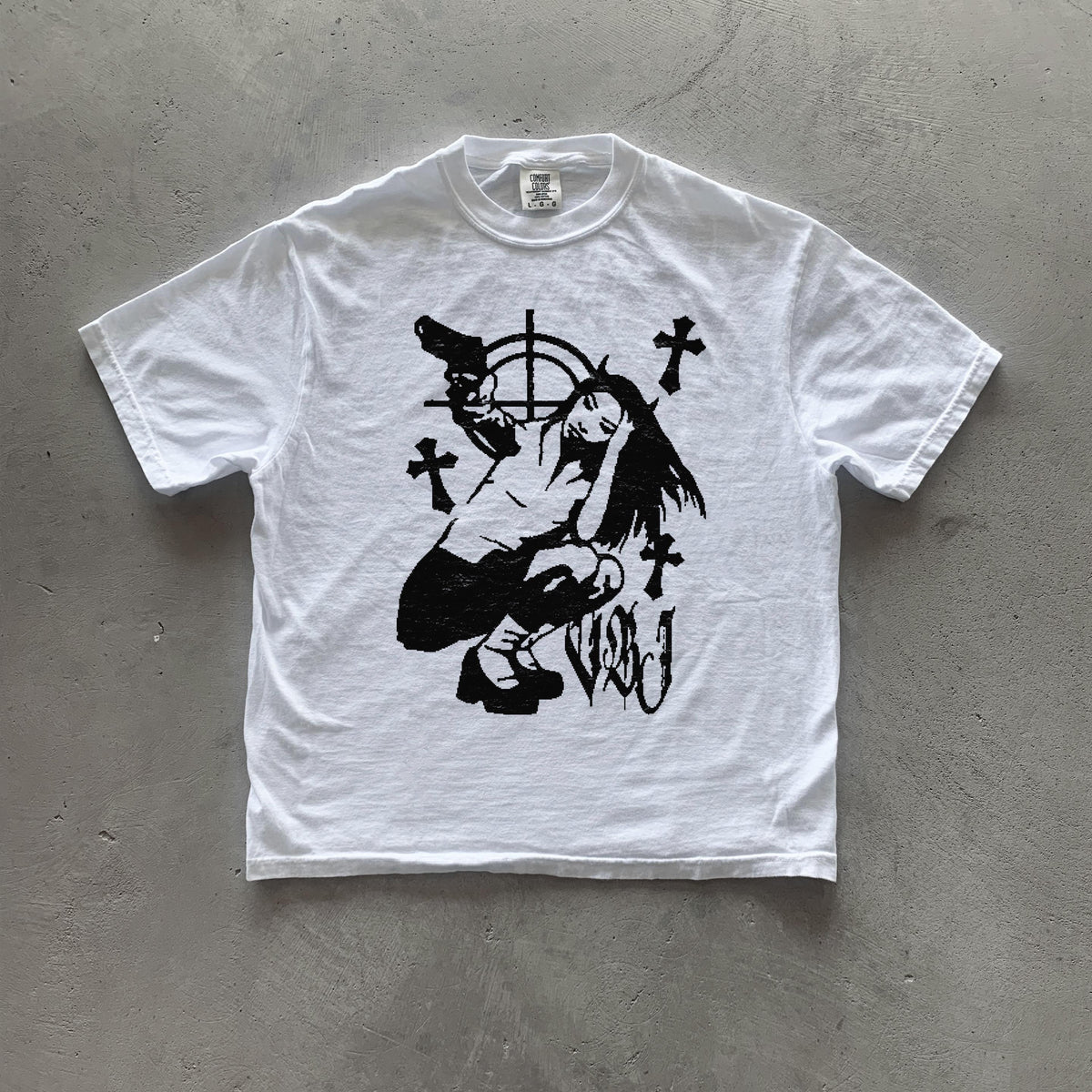 May include: White t-shirt featuring a black screen print graphic of a girl crouching with a gun, surrounded by crosses and a target symbol. The text 'V&J' is also printed on the shirt.